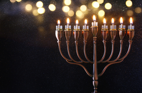 Low key Image of jewish holiday Hanukkah background with menorah