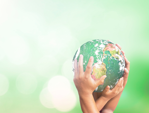 Many hands holding globe