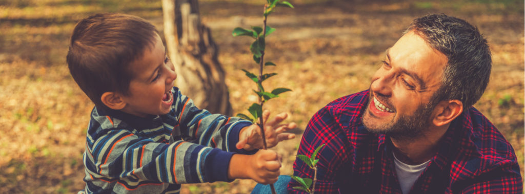 father and child planting together