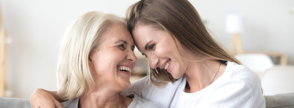 mother and daughter head to head smiling