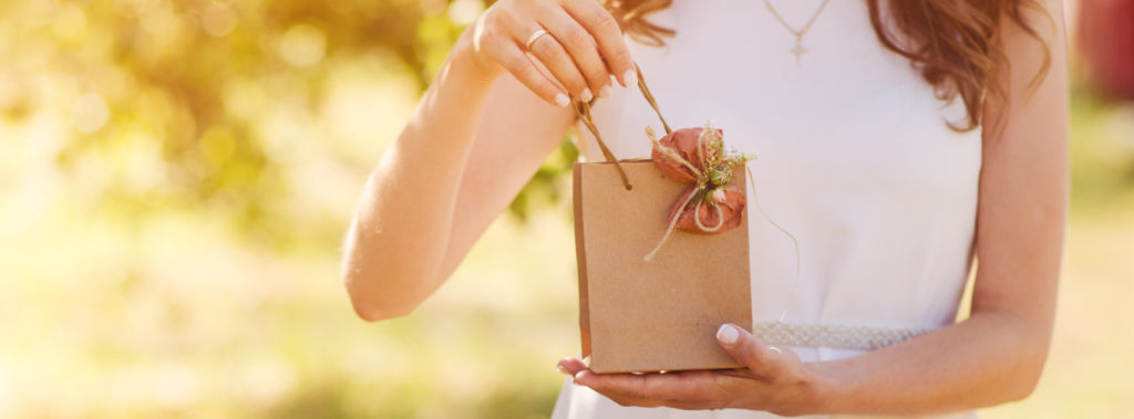 Bride holding a gift bag.