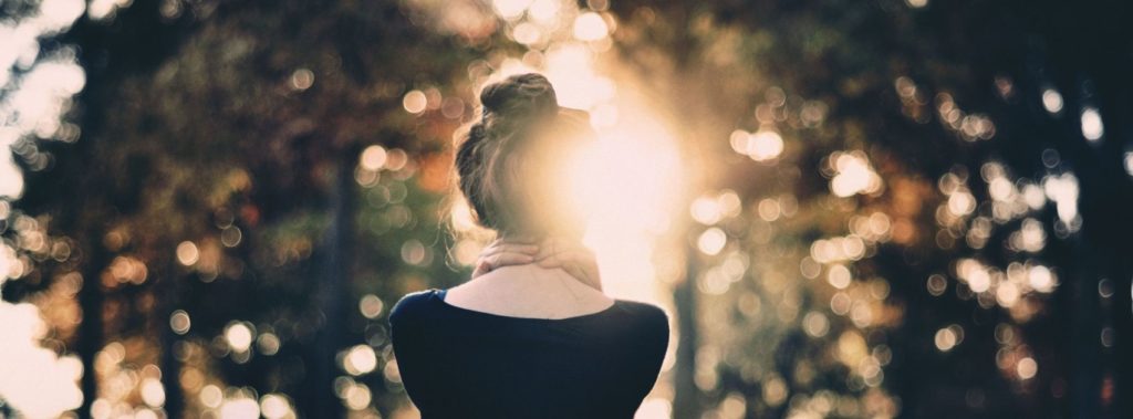 Young woman standing outside in autumn, embracing the new season.