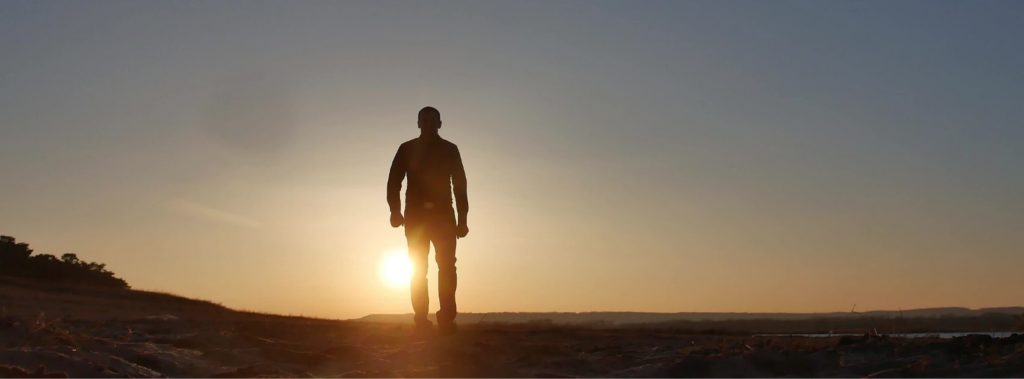 Man walking at sunset.