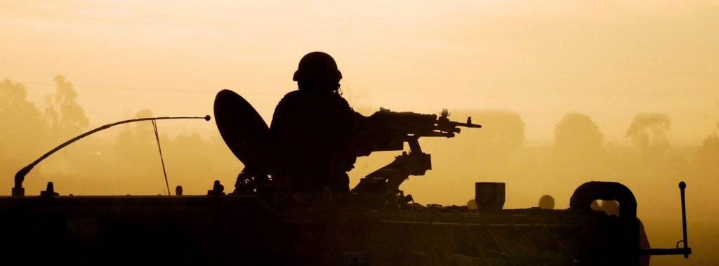 Soldier in tank representing Middle East in conflict.