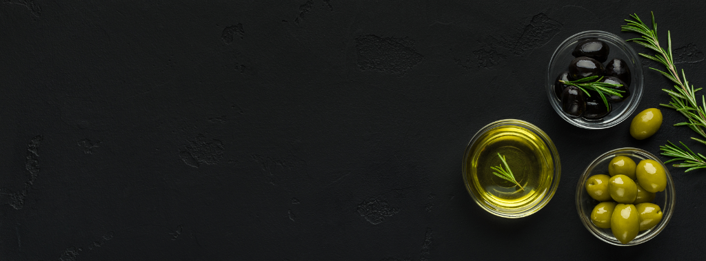 Olive oil, rosemary, and olives on black background.