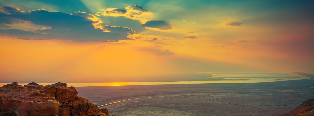 A beautiful sunrise over Masada fortress representing the current land of Israel.